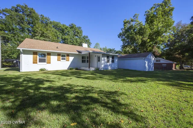a swimming pool with trees in the background