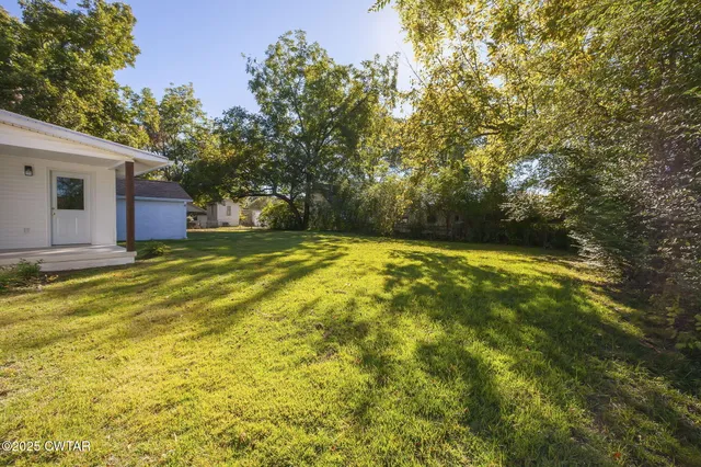 a view of outdoor space with deck and yard