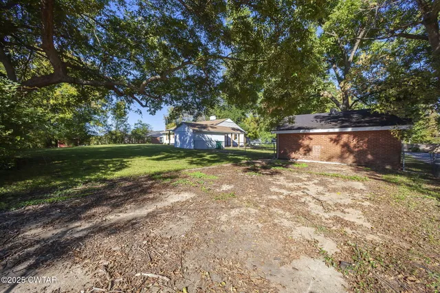 a backyard of a house with lots of green space