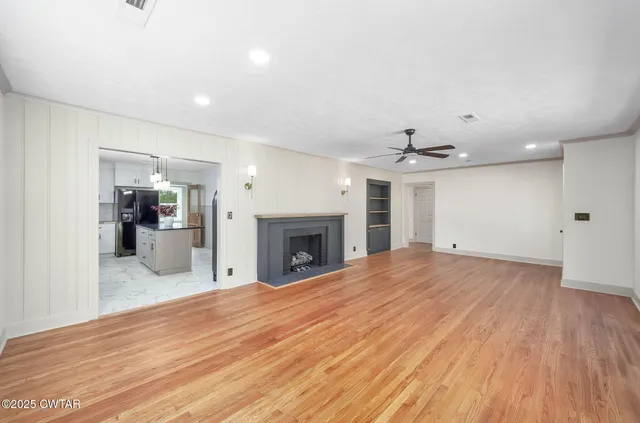 a view of a kitchen with a sink and a fireplace