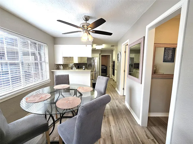a view of a dining room with furniture window and wooden floor