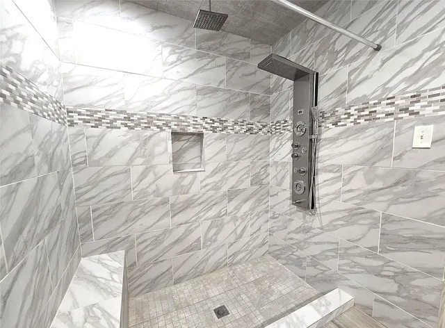 a view of a hallway with wooden floor and stairs