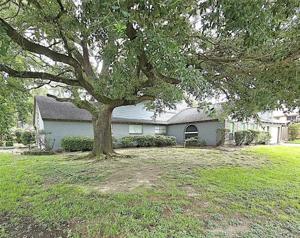 a room with wooden floor pool table furniture and windows