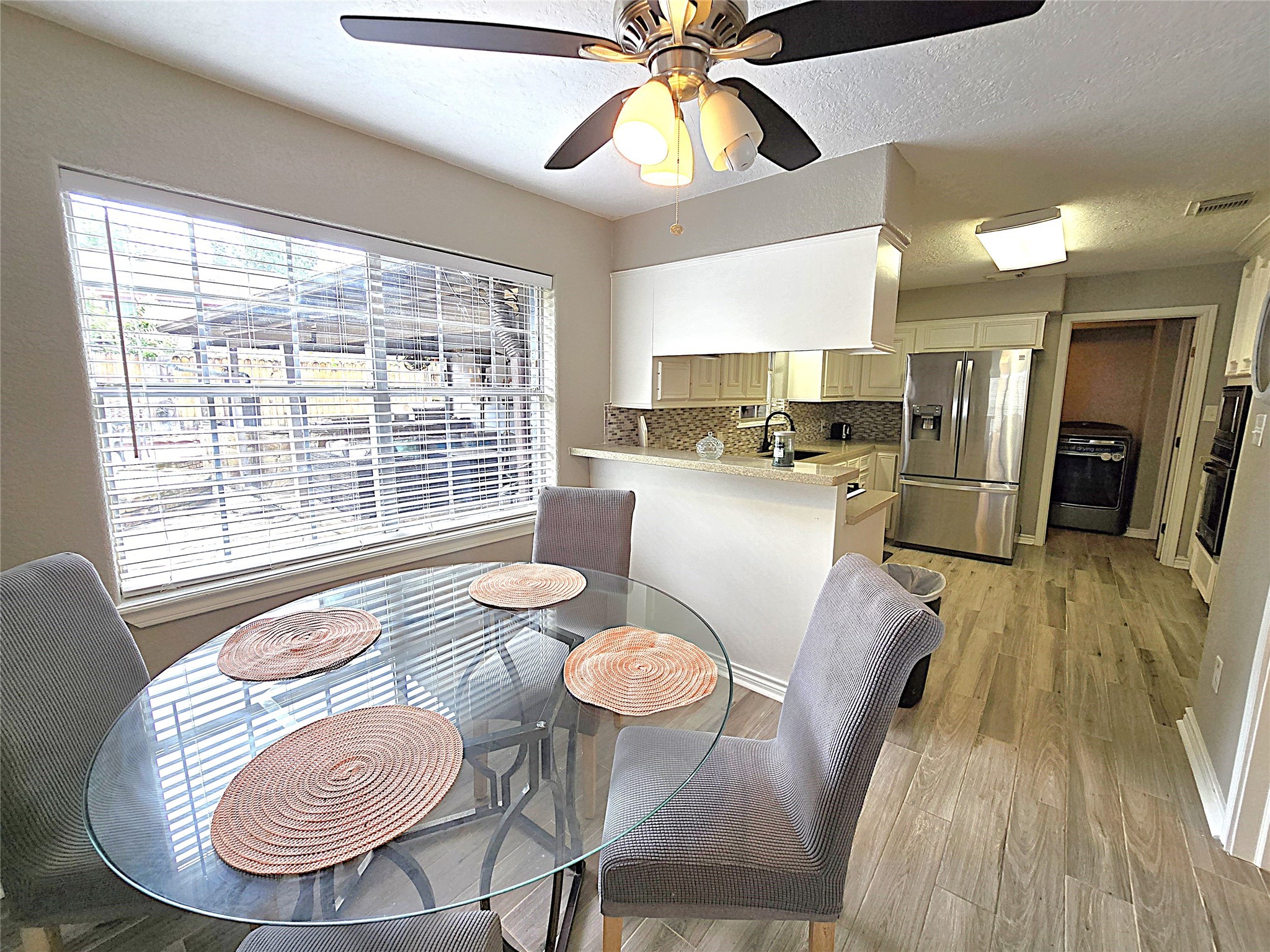 560 Brandon Road Conroe, TX 77302 - Photo 26 of 45 a kitchen with furniture wooden floor and a window