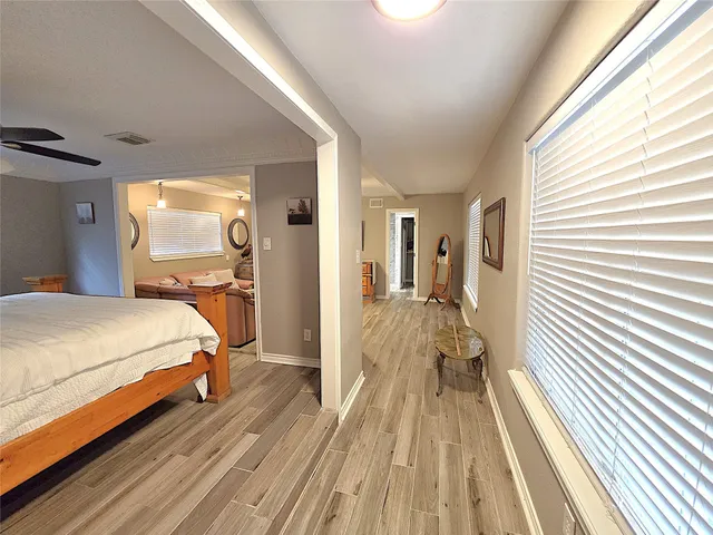 a bedroom with a bed and wooden floor