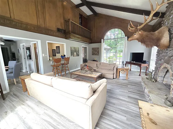 a living room with furniture fireplace and a large window