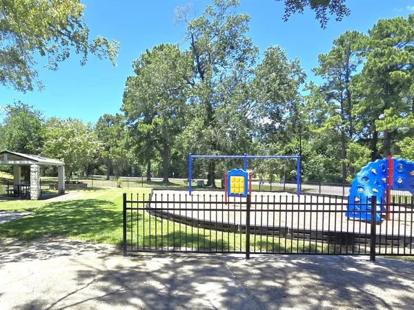 a view of a deck with a fence and trees