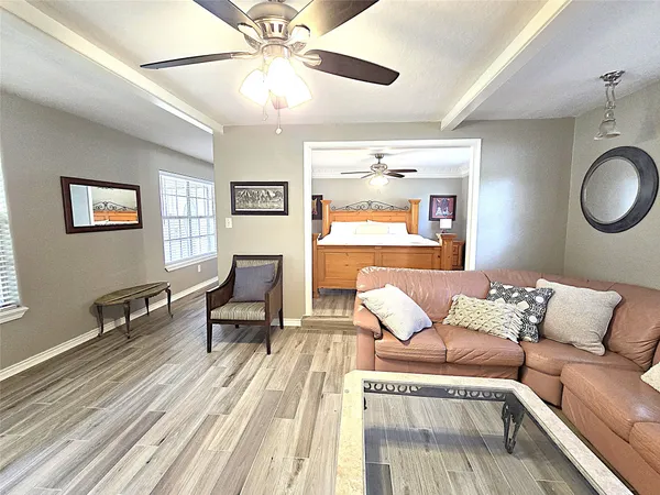 a living room with furniture and wooden floor