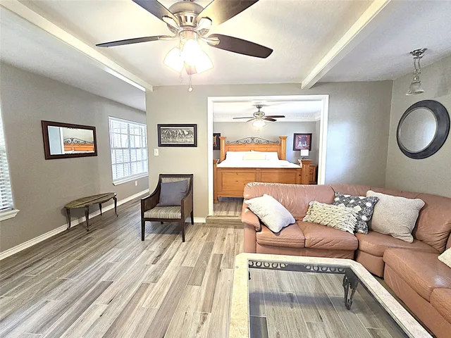 a living room with furniture and wooden floor