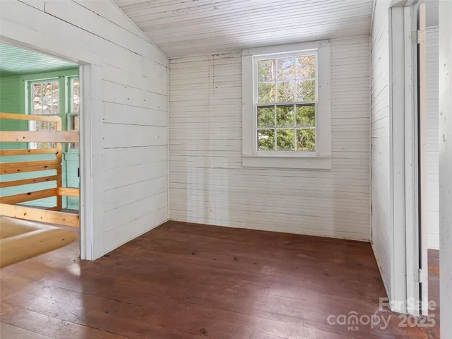 a view of room with window and wooden floor