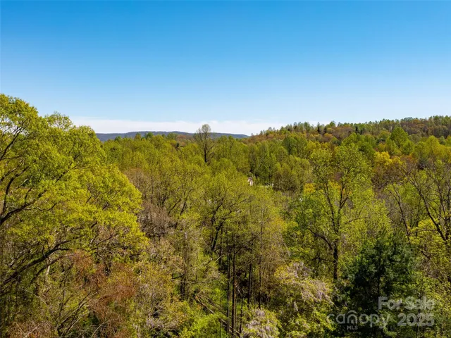 a view of a small house with a tree in the background