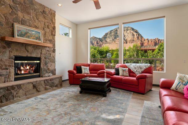 610 Rodeo Road Sedona, AZ 86336 - Photo 1 of 20 a living room with furniture a large window and a fireplace