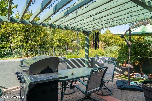 610 Rodeo Road Sedona, AZ 86336 - Photo 15 of 20 a view of backyard with table and chair and potted plants