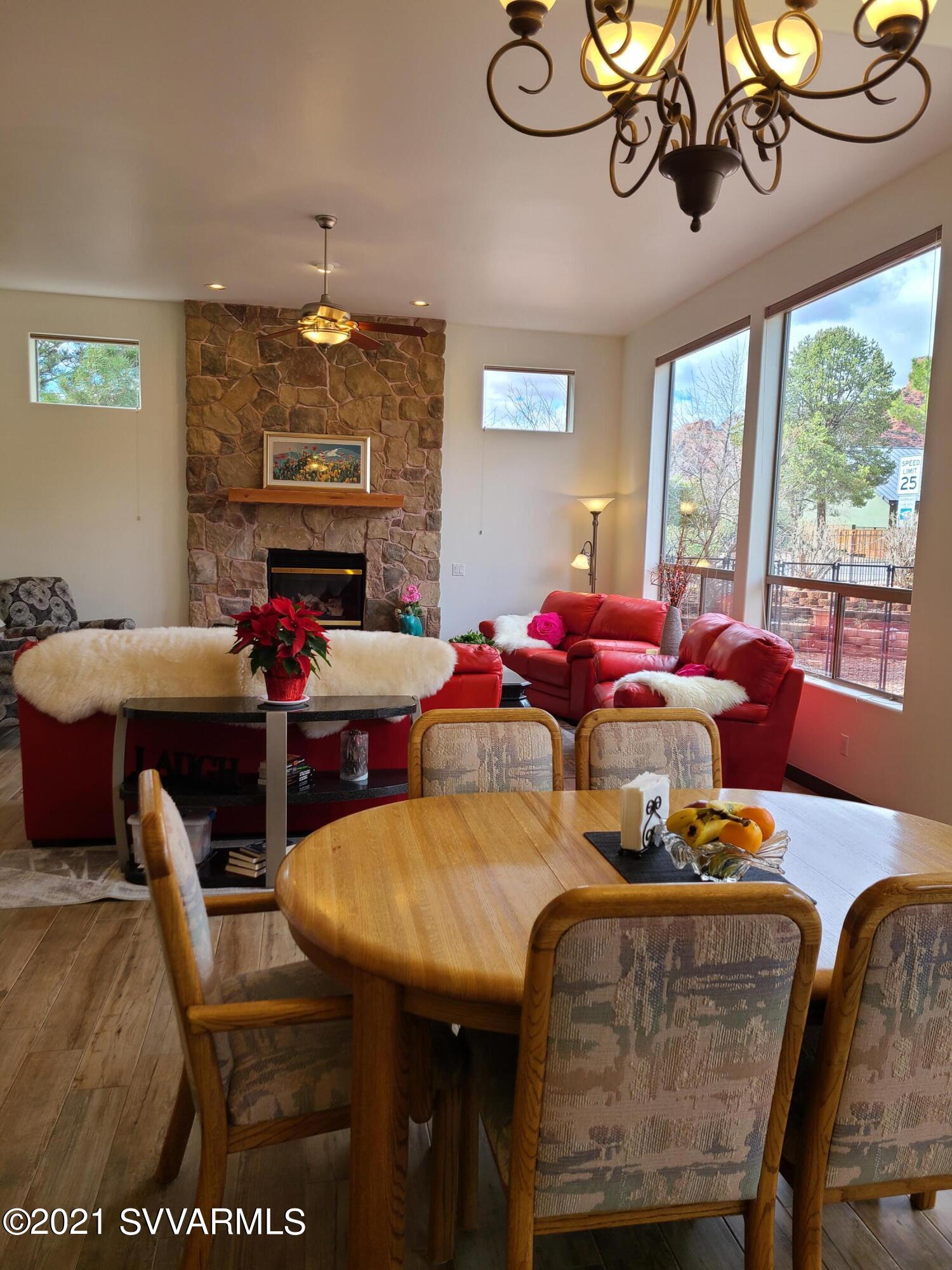610 Rodeo Road Sedona, AZ 86336 - Photo 3 of 20 a dining room with furniture a large window and a chandelier
