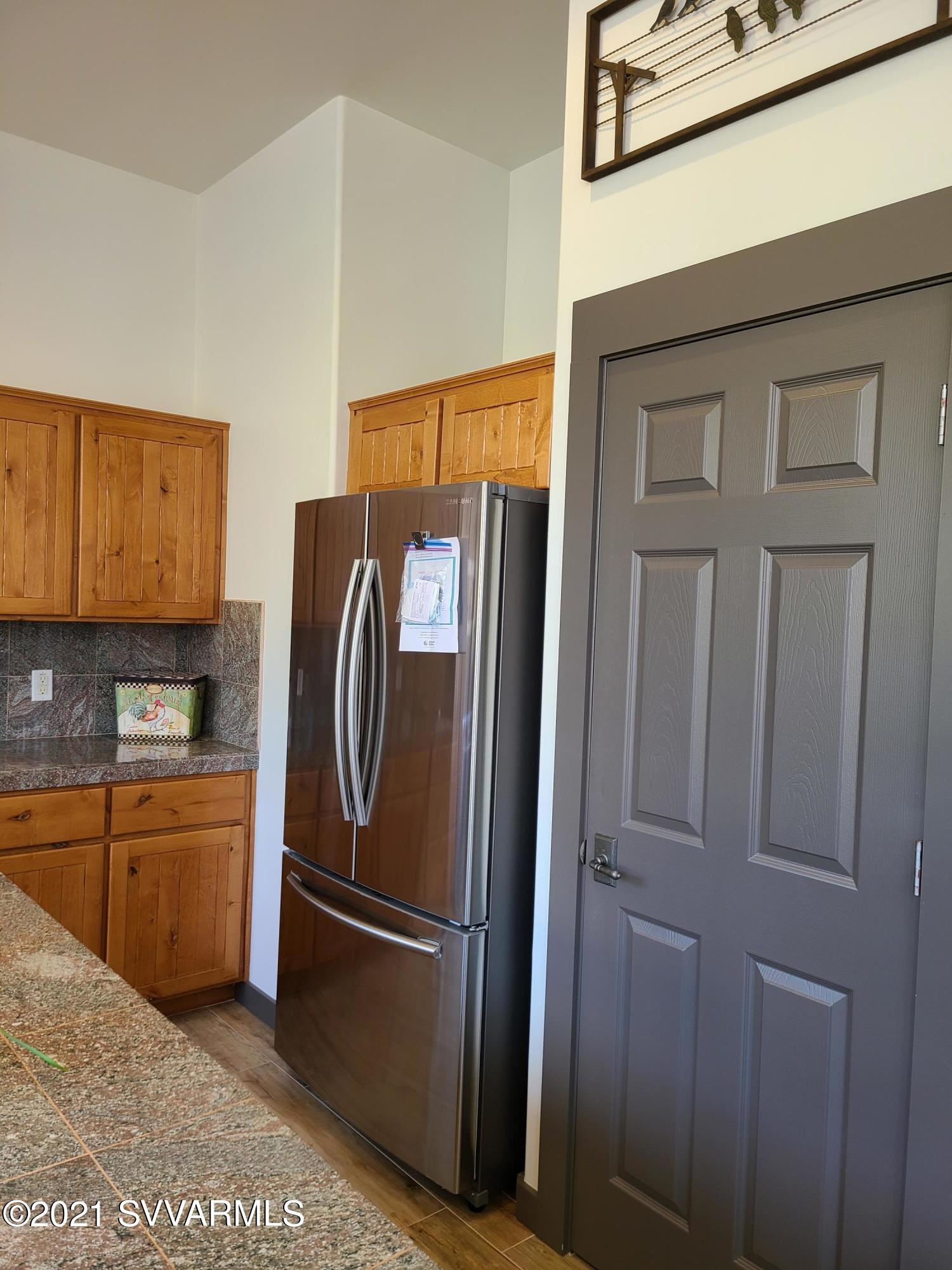 610 Rodeo Road Sedona, AZ 86336 - Photo 5 of 20 a metallic refrigerator freezer sitting in a kitchen