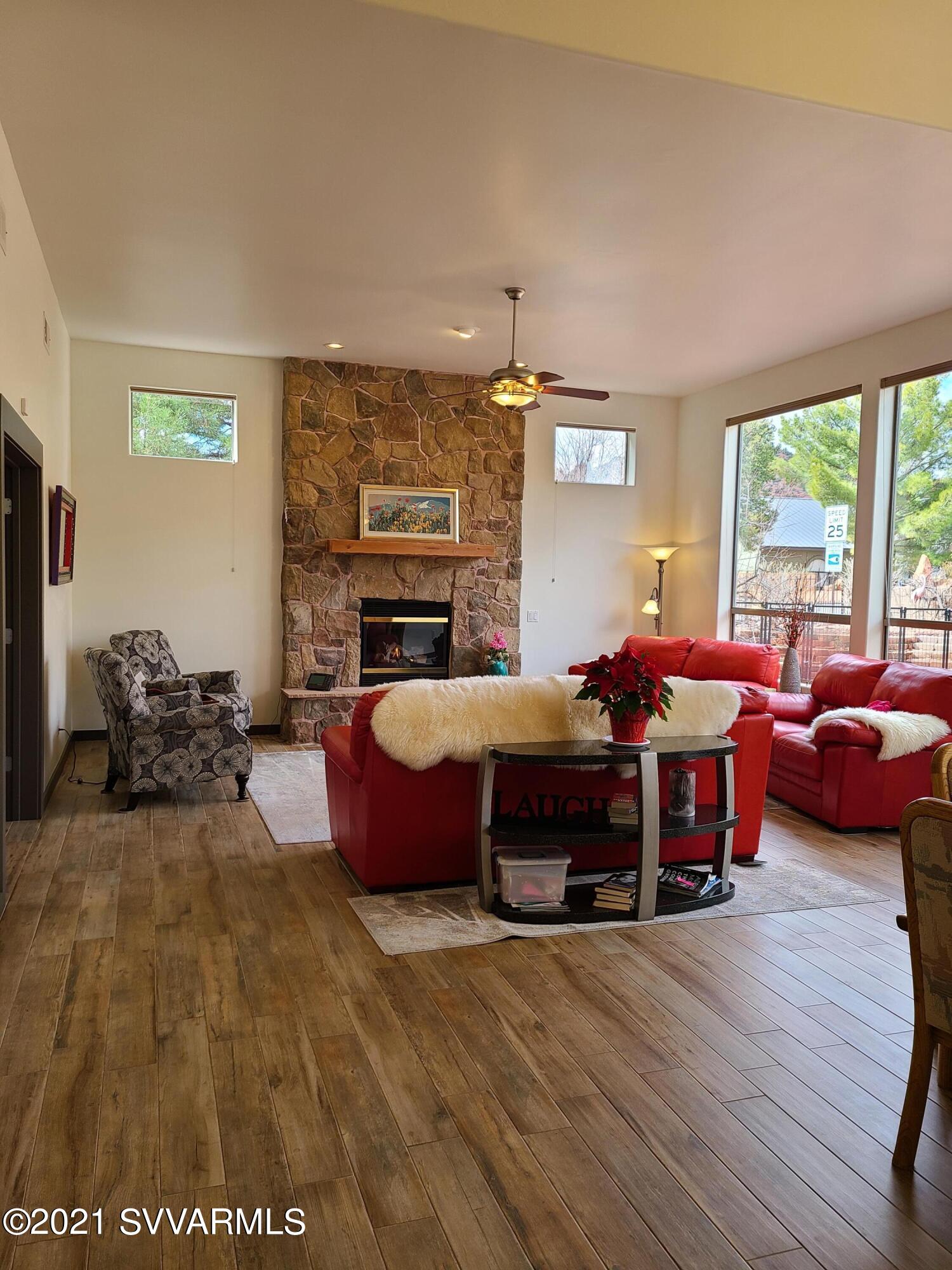 610 Rodeo Road Sedona, AZ 86336 - Photo 6 of 20 a living room with furniture fireplace and a large window