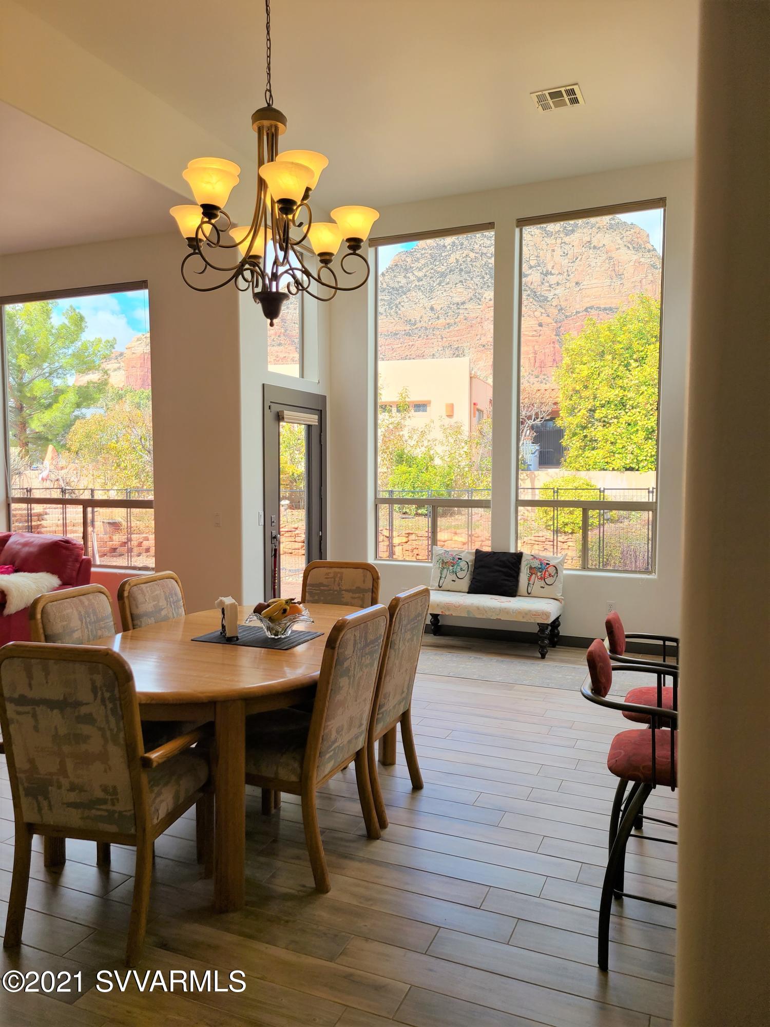 610 Rodeo Road Sedona, AZ 86336 - Photo 7 of 20 a view of a dining room with furniture a chandelier and wooden floor