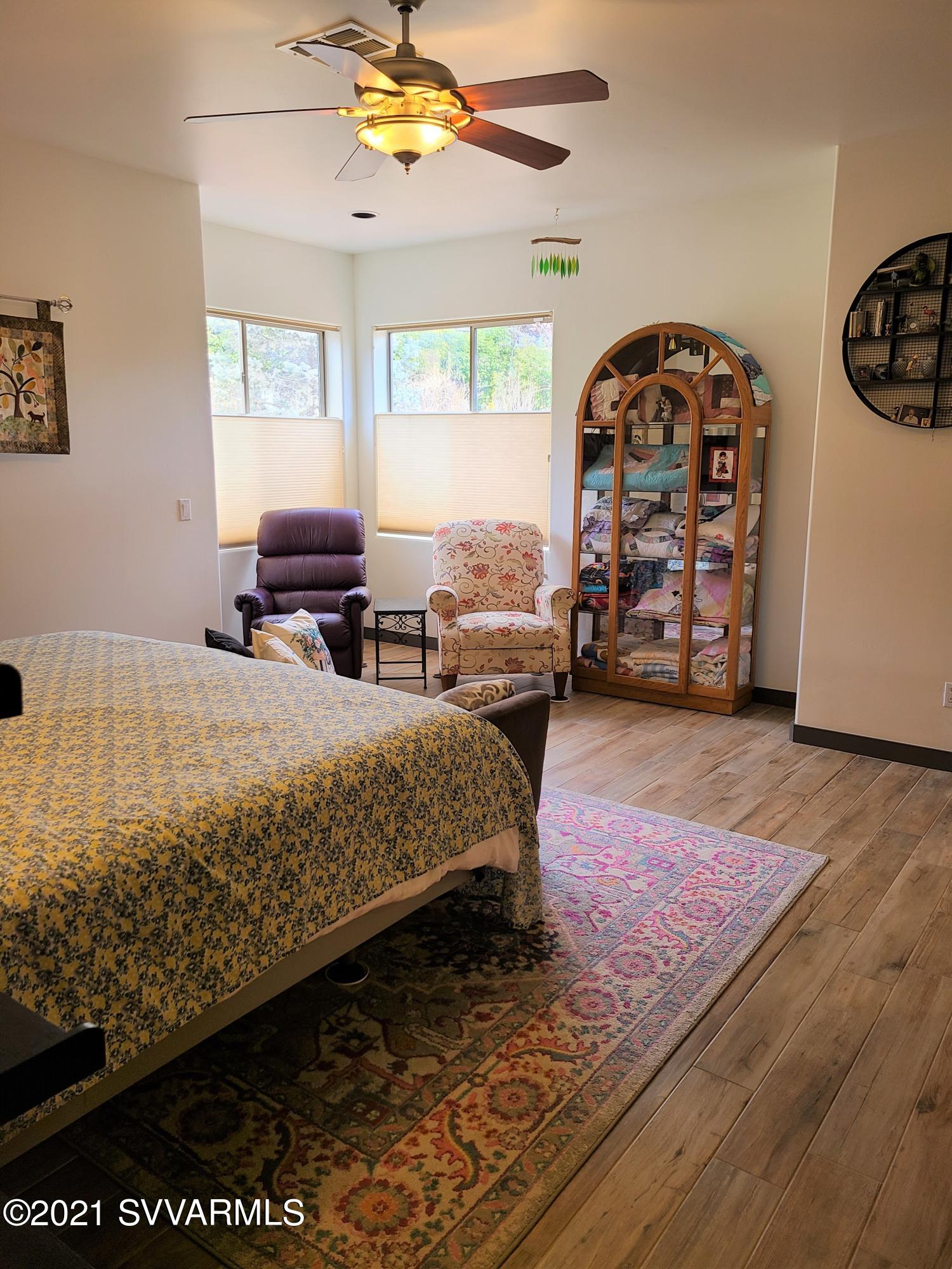 610 Rodeo Road Sedona, AZ 86336 - Photo 9 of 20 a bedroom with a bed a table and a large window