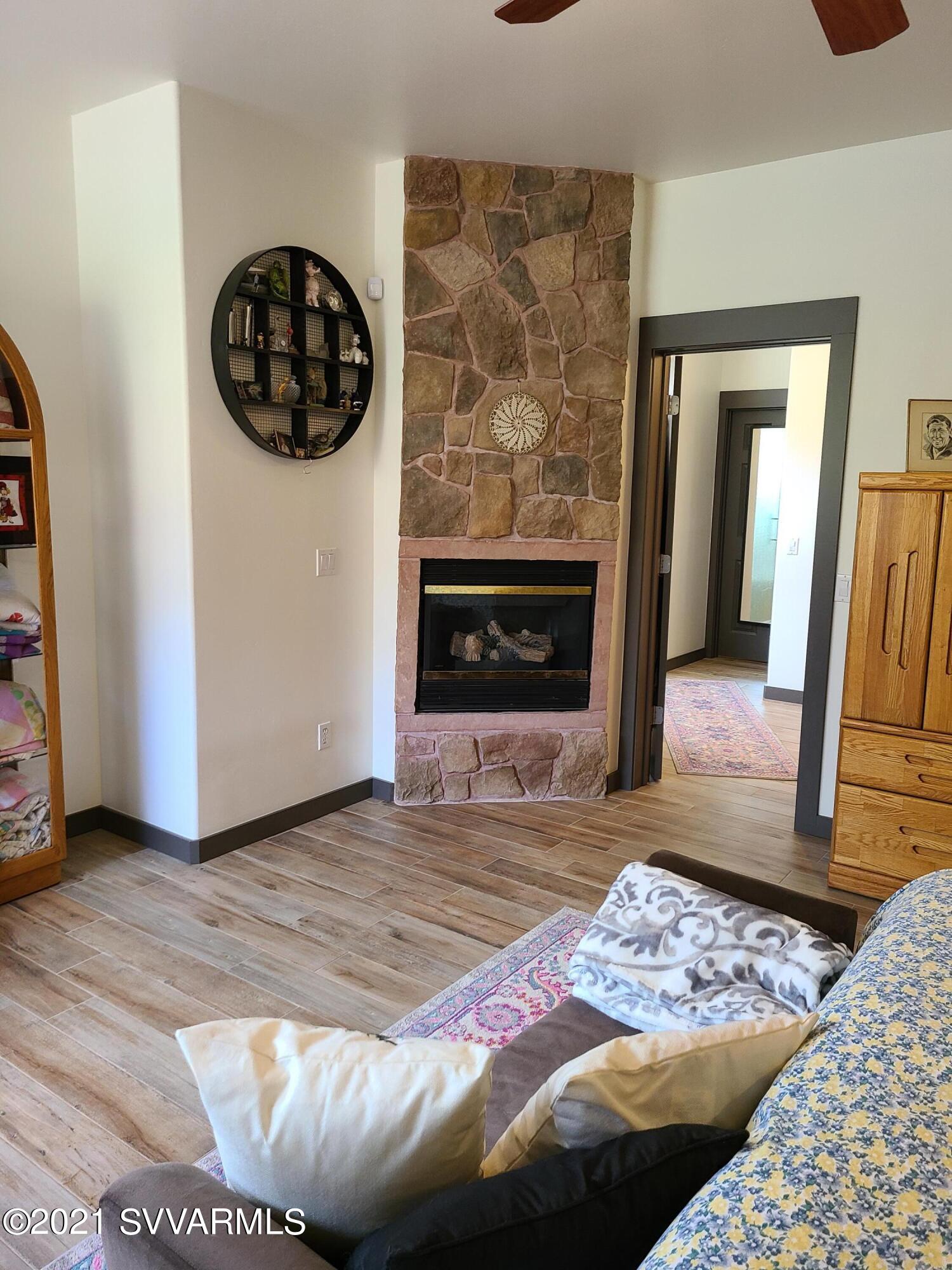 610 Rodeo Road Sedona, AZ 86336 - Photo 10 of 20 a view of an empty room with wooden floor and fire place