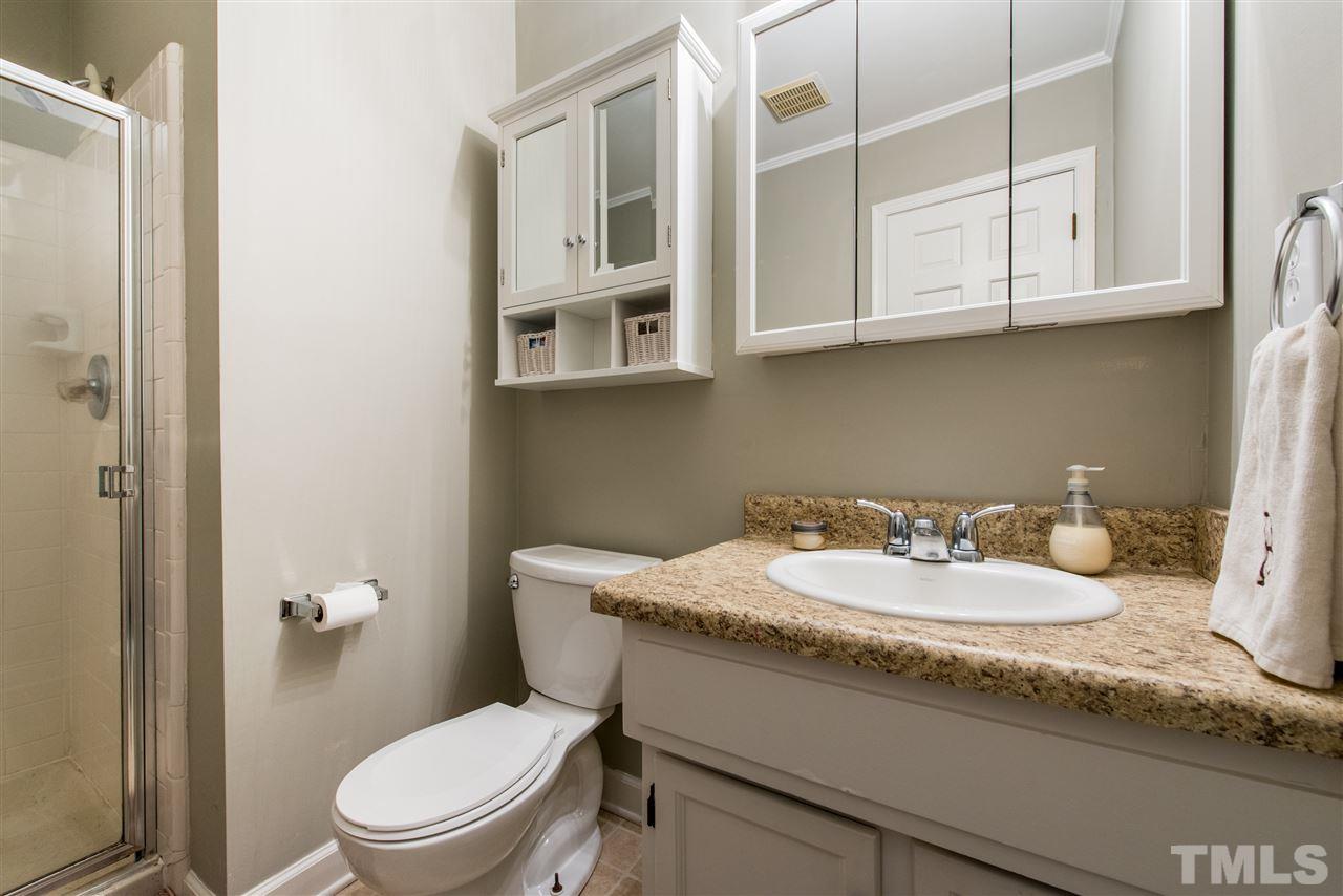 3512 Peach Haven Court Raleigh, NC 27607 - Photo 17 of 25 a bathroom with a granite countertop toilet sink and mirror