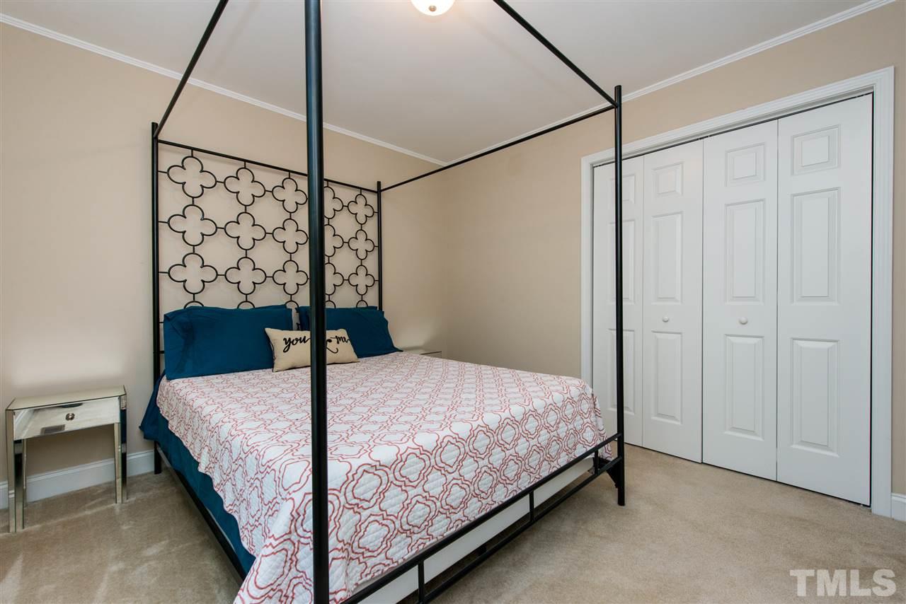 3512 Peach Haven Court Raleigh, NC 27607 - Photo 19 of 25 a bedroom with a bed and a table
