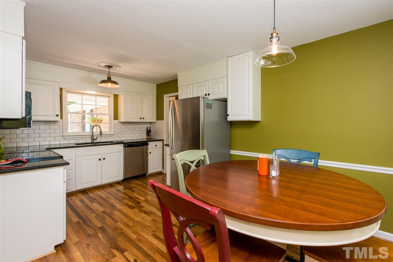3512 Peach Haven Court Raleigh, NC 27607 - Photo 3 of 25 a kitchen with stainless steel appliances granite countertop a sink dishwasher and a refrigerator with wooden floor