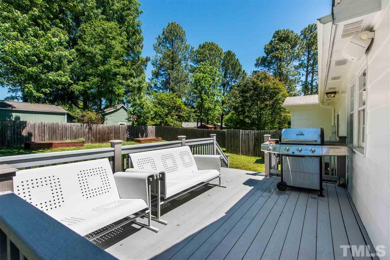 3512 Peach Haven Court Raleigh, NC 27607 - Photo 22 of 25 a view of house with deck outdoor seating and trees in the background
