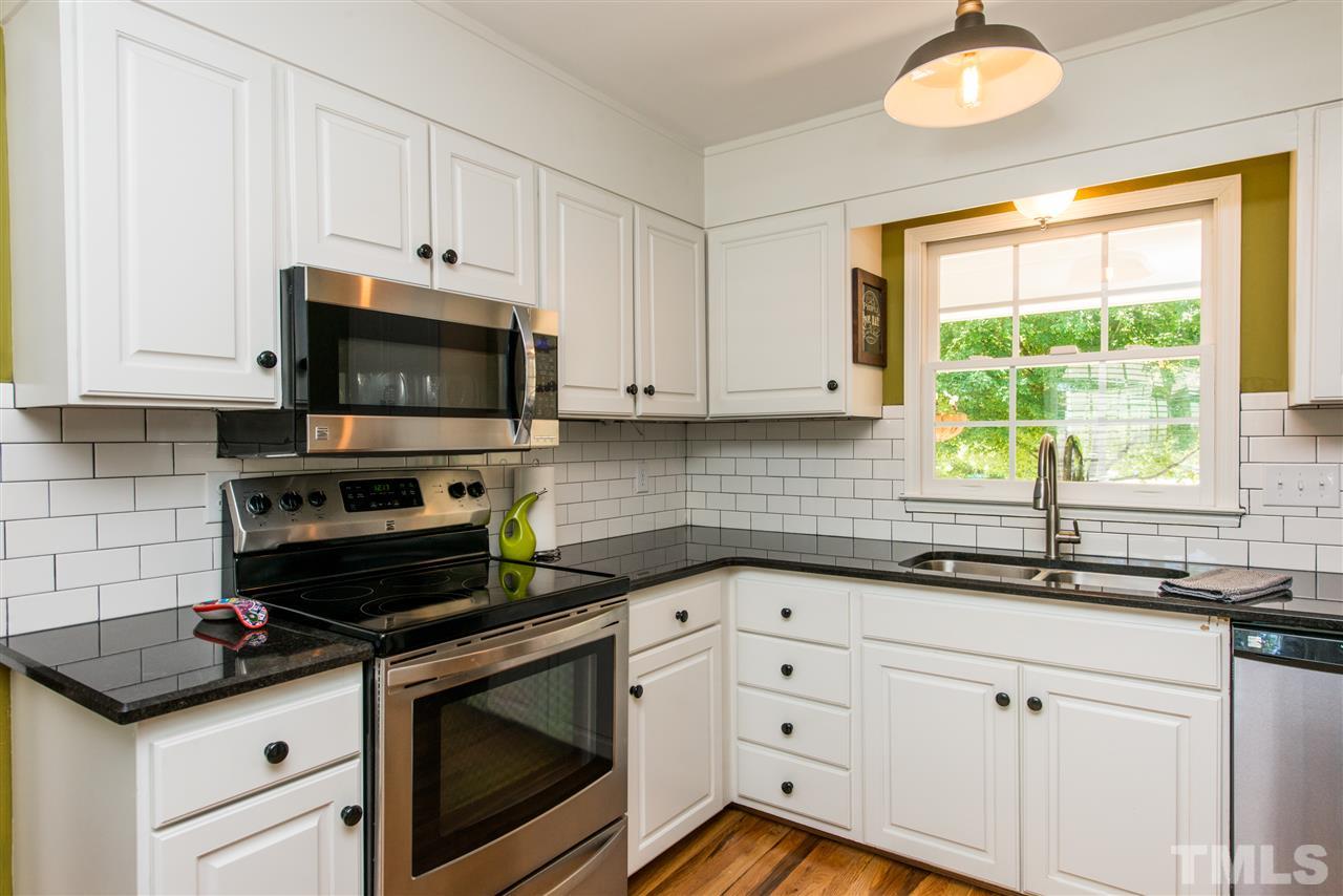 3512 Peach Haven Court Raleigh, NC 27607 - Photo 4 of 25 a kitchen with granite countertop white cabinets stainless steel appliances and a window