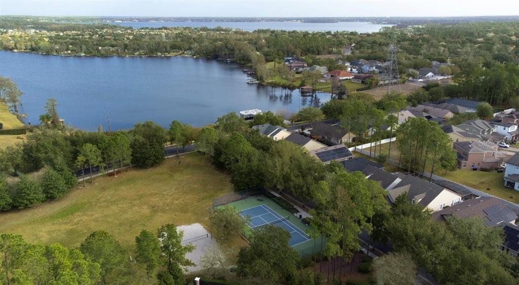 6673 Duncaster Street Windermere, FL 34786 - Photo 23 of 25 an aerial view of green landscape with trees houses and lake view