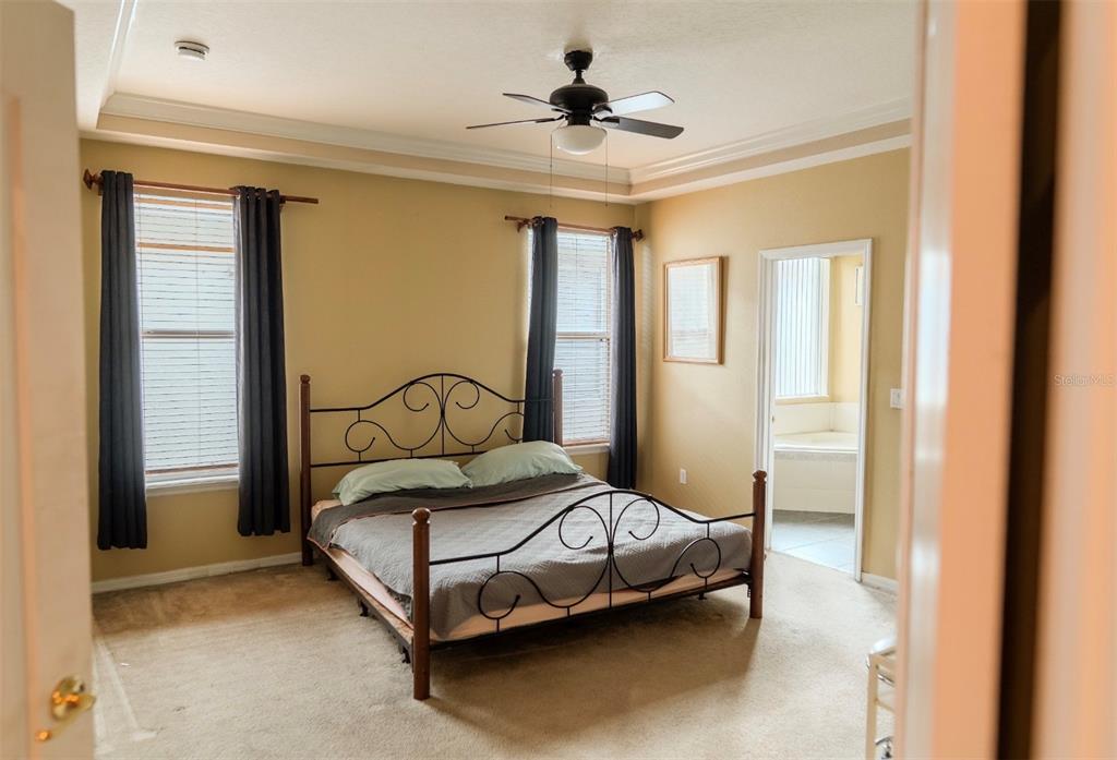 6673 Duncaster Street Windermere, FL 34786 - Photo 8 of 25 a bedroom with a bed and a window