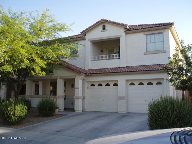 2933 East Blue Sage Road Gilbert, AZ 85297 - Photo 1 of 18 a view of a white house with a small yard and plants