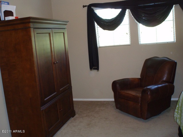 2933 East Blue Sage Road Gilbert, AZ 85297 - Photo 15 of 18 a living room with furniture and a window