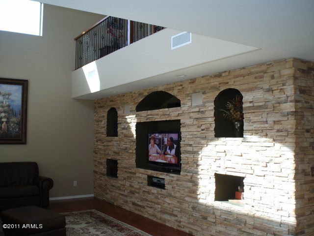 2933 East Blue Sage Road Gilbert, AZ 85297 - Photo 2 of 18 a living room with fireplace furniture and a wooden floor