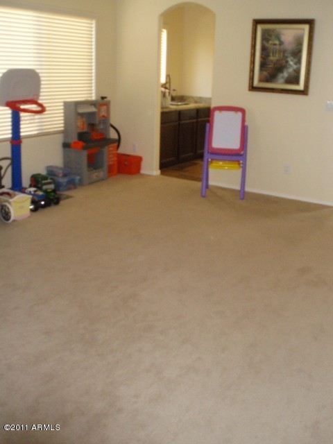 2933 East Blue Sage Road Gilbert, AZ 85297 - Photo 5 of 18 a room with furniture and a flat screen tv