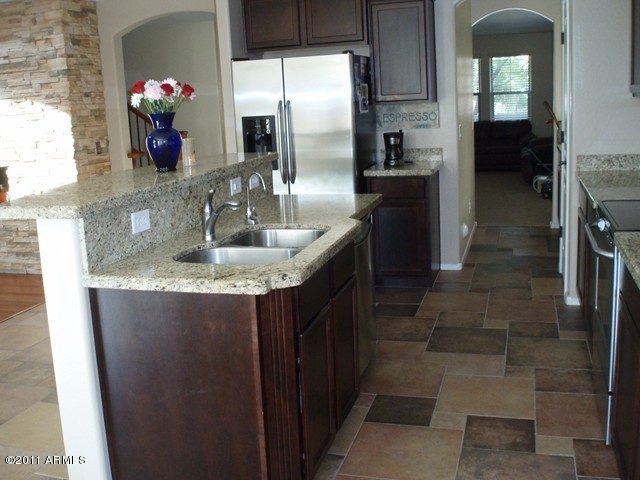 2933 East Blue Sage Road Gilbert, AZ 85297 - Photo 6 of 18 a kitchen with a sink and refrigerator