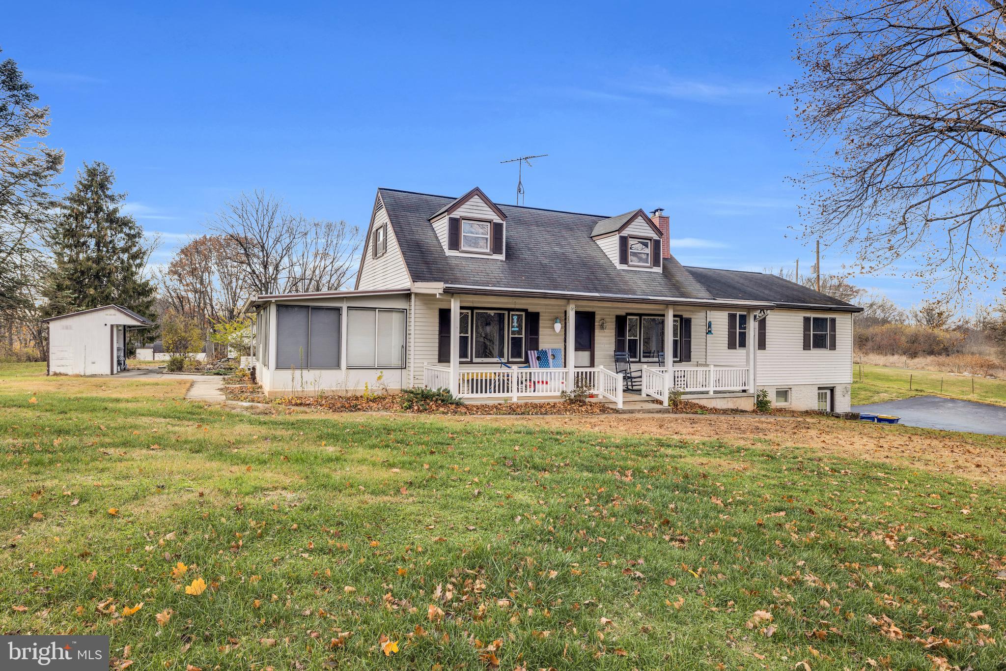 Front photo with 4 Seasons room and sitting porch