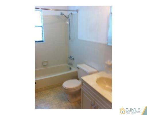 1916 Raspberry Court Edison, NJ 08817 - Photo 7 of 8 a bathroom with a toilet and a bath tub