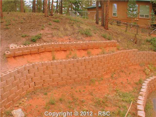 8211 Inca Road Larkspur, CO 80118 - Photo 22 of 24 Lovely retaining walls make gardening oportuinites.