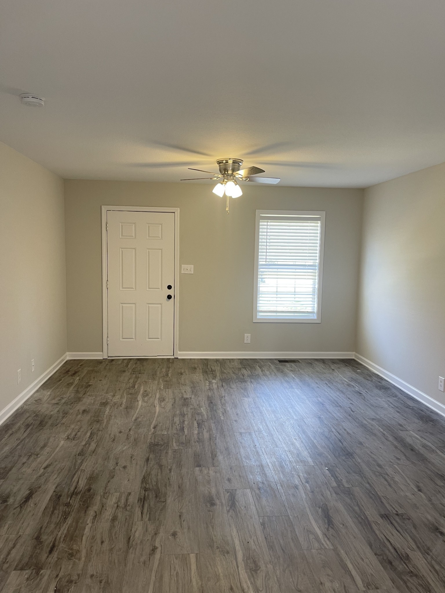1845 Hugh Hunter Road Oak Grove, KY 42262 - Photo 2 of 6 wooden floor in an empty room with a window