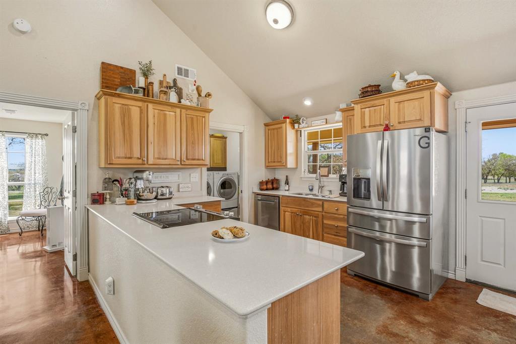 7915 East Fm 580 Kempner, TX 76539 - Photo 11 of 39 a kitchen that has a kitchen island wooden cabinets and stainless steel appliances