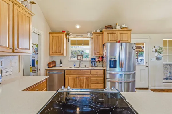 a kitchen with stainless steel appliances a refrigerator and a stove
