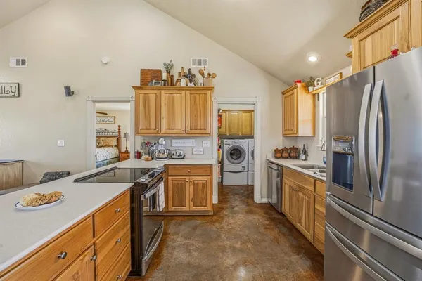 a kitchen with stainless steel appliances granite countertop a sink stove and refrigerator