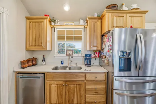 a kitchen with stainless steel appliances a sink stove and refrigerator
