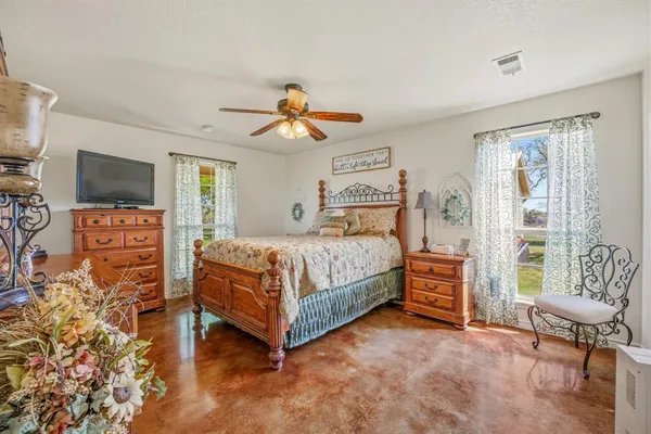 a bedroom with a bed and a television