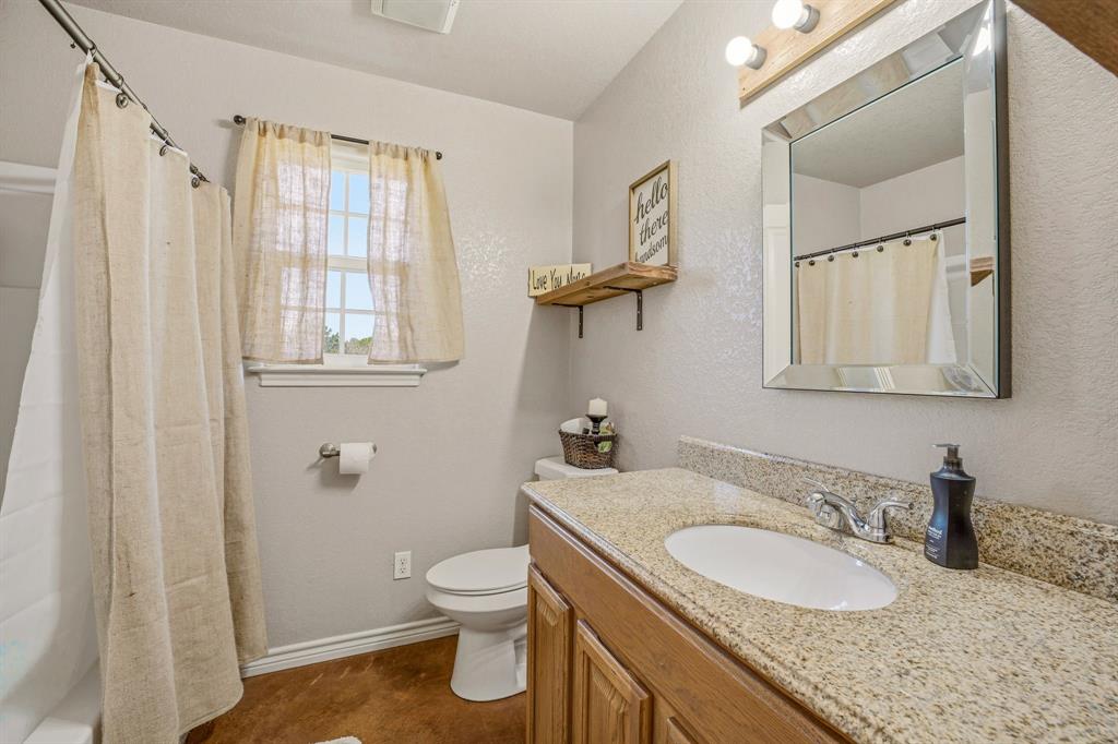 7915 East Fm 580 Kempner, TX 76539 - Photo 20 of 39 a bathroom with a granite countertop sink toilet and mirror
