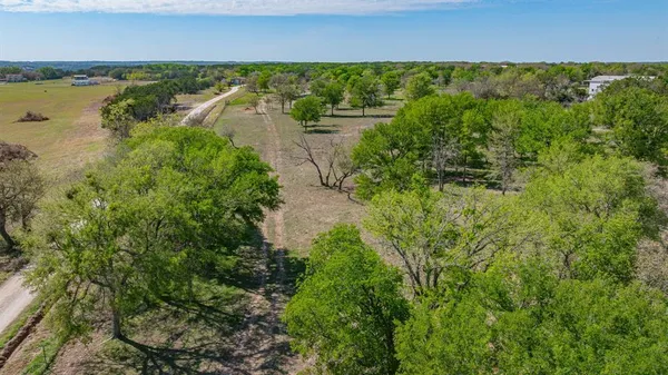 an aerial view of a houses with a yard