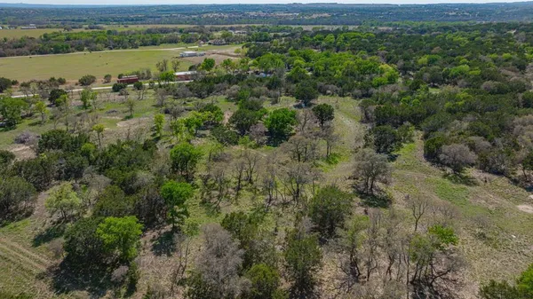 an aerial view of ocean and residential houses with outdoor space