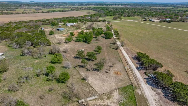 an aerial view of a houses with a yard