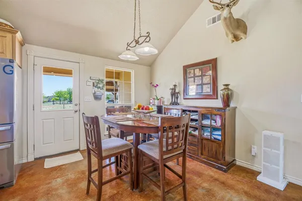 a view of a dining room with furniture and a chandelier
