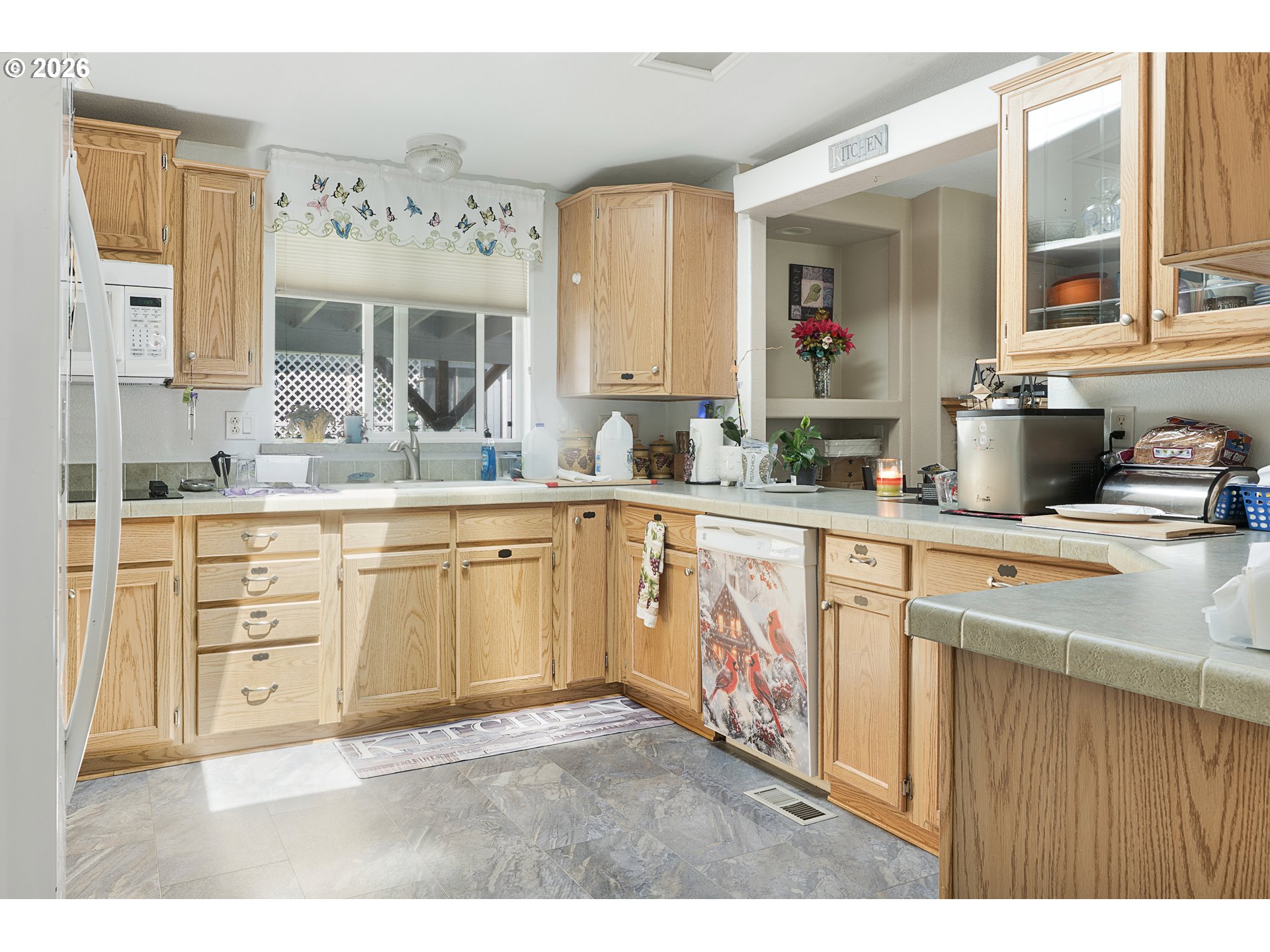 96465 Coverdell Road, Unit 8 Brookings, OR 97415 - Photo 2 of 16 a kitchen with cabinets stainless steel appliances a sink and a large window